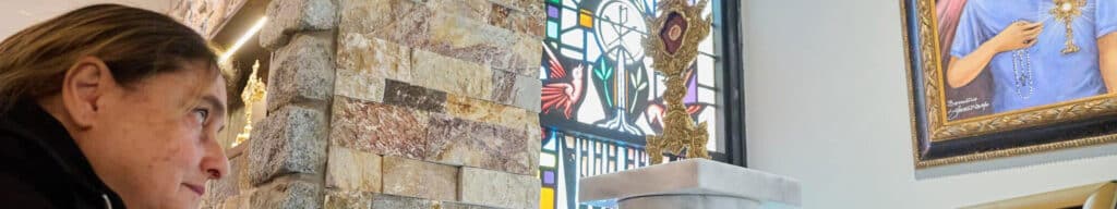 The mother of Carlo Acutis looks at her son.