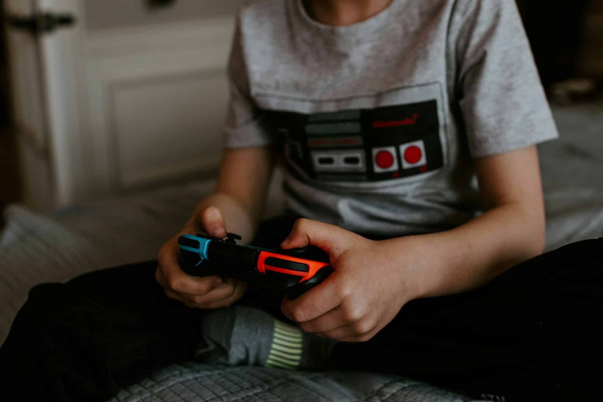 Boy playing a video game | Photo by Kelly Sikkema on Unsplash