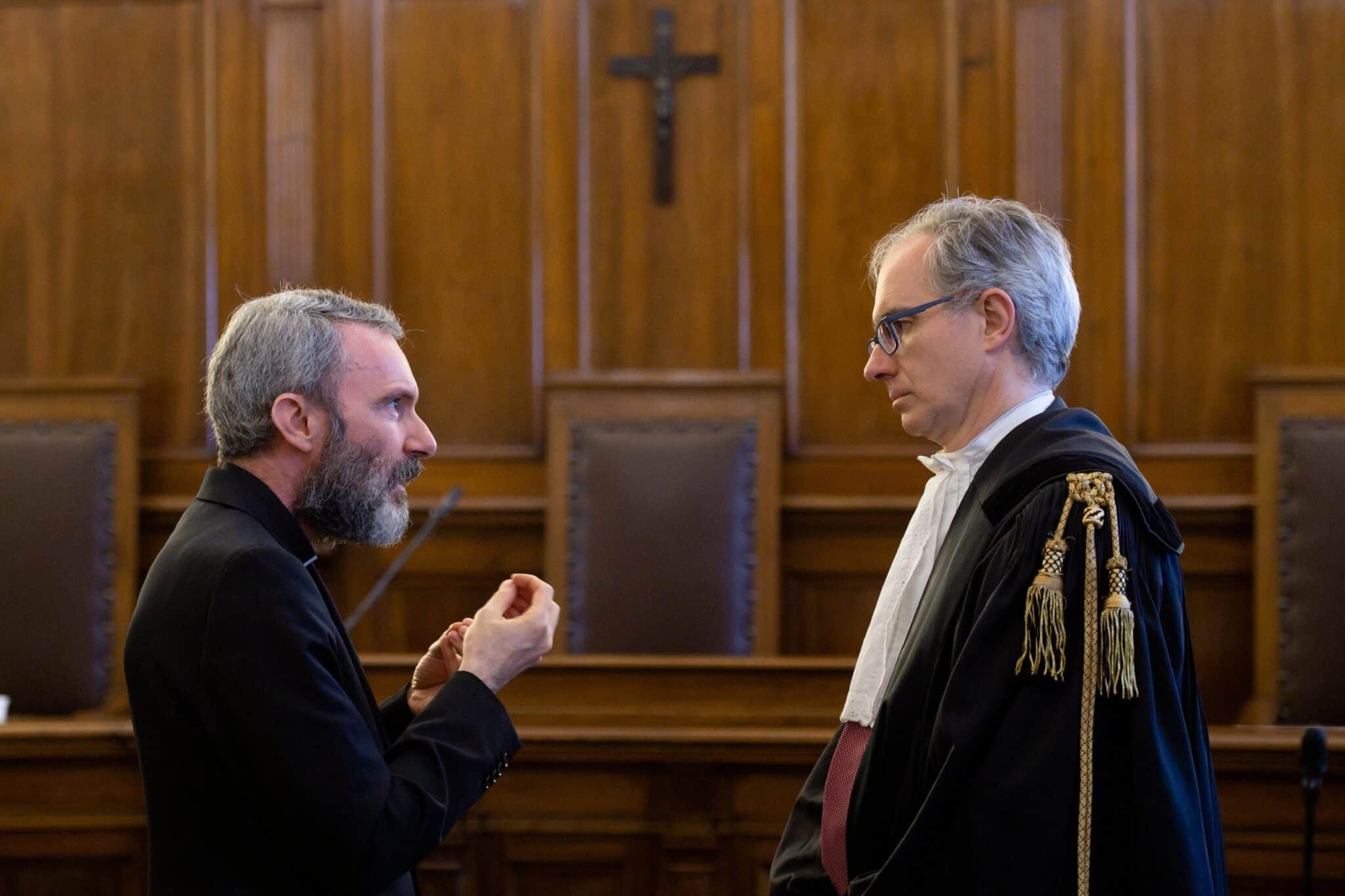 Msgr. Carlo Alberto Capella, left, a former Vatican diplomat who served in Washington, talks to his lawyer during his sentencing in a Vatican court in this June 23, 2018, file photo.