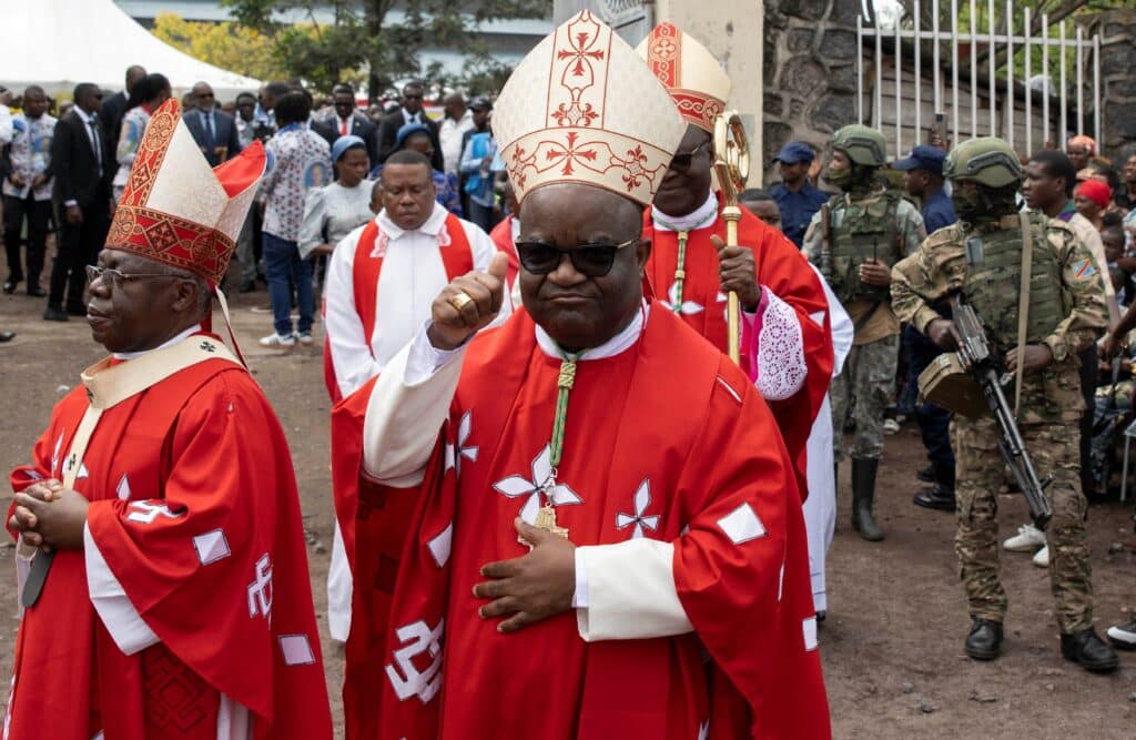 Congolese Bishop Willy Ngumbi Ngengele of Goma gestures alongside other prelates following Mass honoring Blessed Floribert Bwana Chui Bin Kositi. Blessed Kositi, a 26-year-old layman from Congo, was a member of the Congolese branch of the Community of Sant'Egidio, which called him "a martyr of corruption." Kidnapped July 7, 2007, after refusing a bribe, his body was discovered two days later with evident signs of torture. Blessed Kositi's remains were transferred from a public cemetery to a cathedral in Congo's eastern city of Goma during a special Mass following his June 15 Vatican beatification. (OSV News photo/Arlette Bashizi, Reuters)