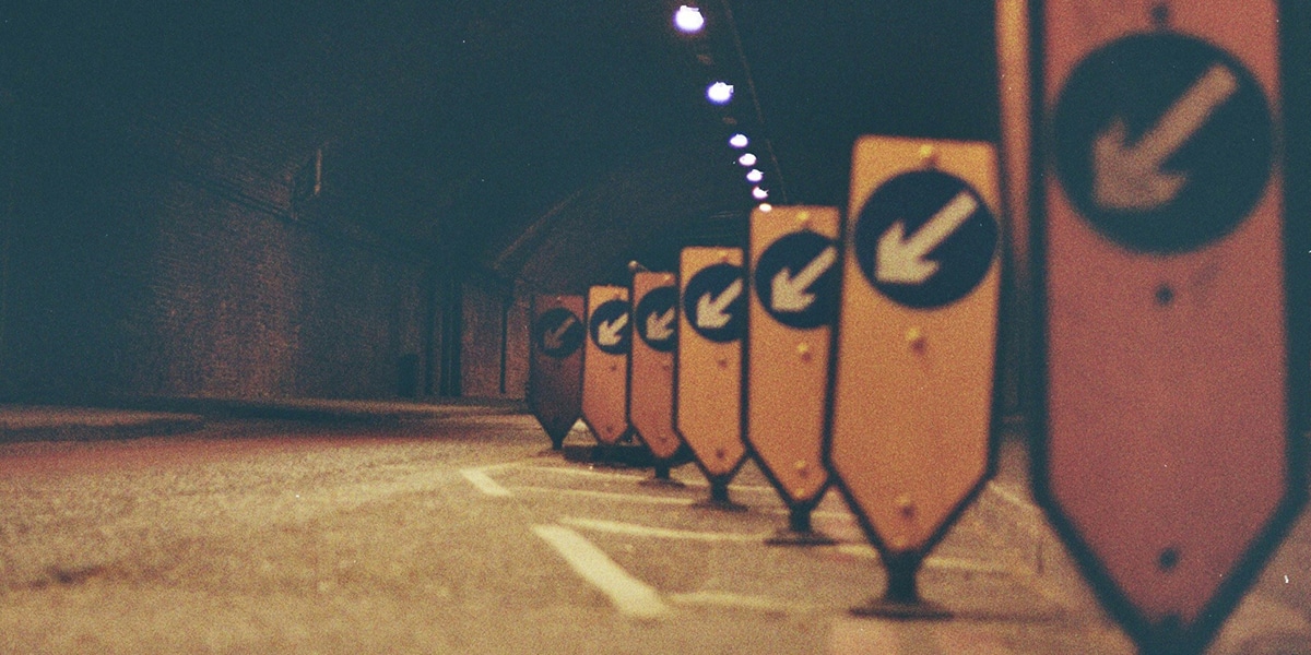 signs with arrows showing a detour and interruption of traffic flow