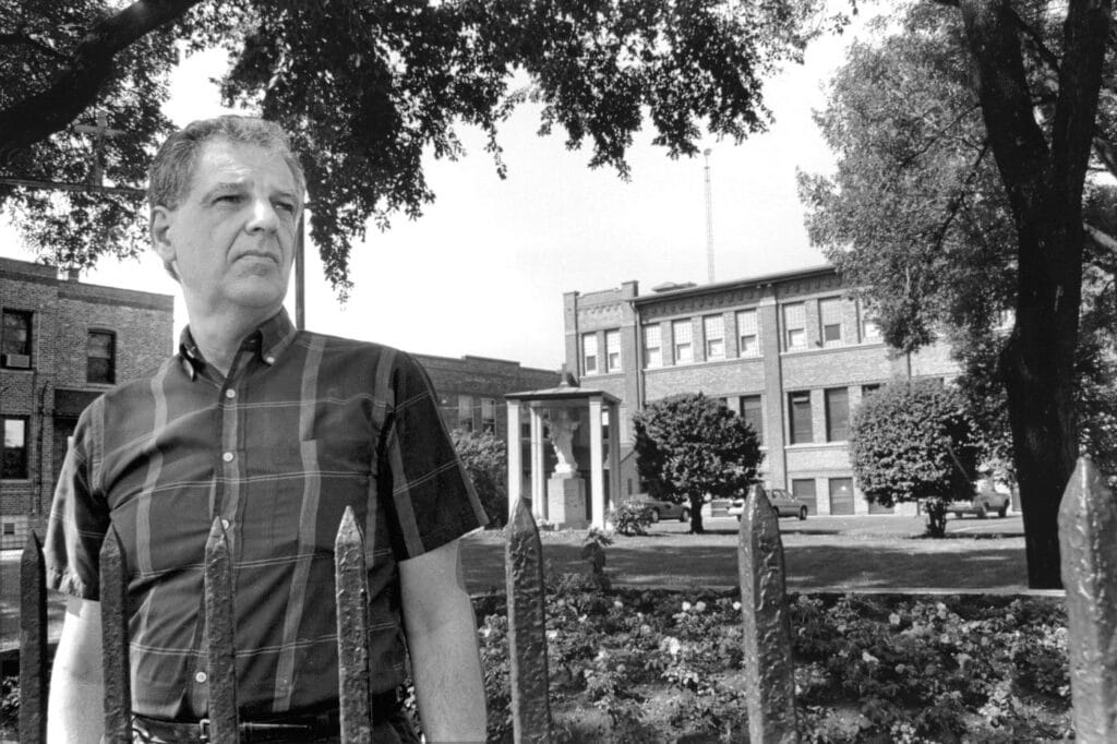 Deacon George Brooks stands outside Kolbe House in Chicago. He has spent five years ministering to criminals in the maximum security section at Cook County Jail.