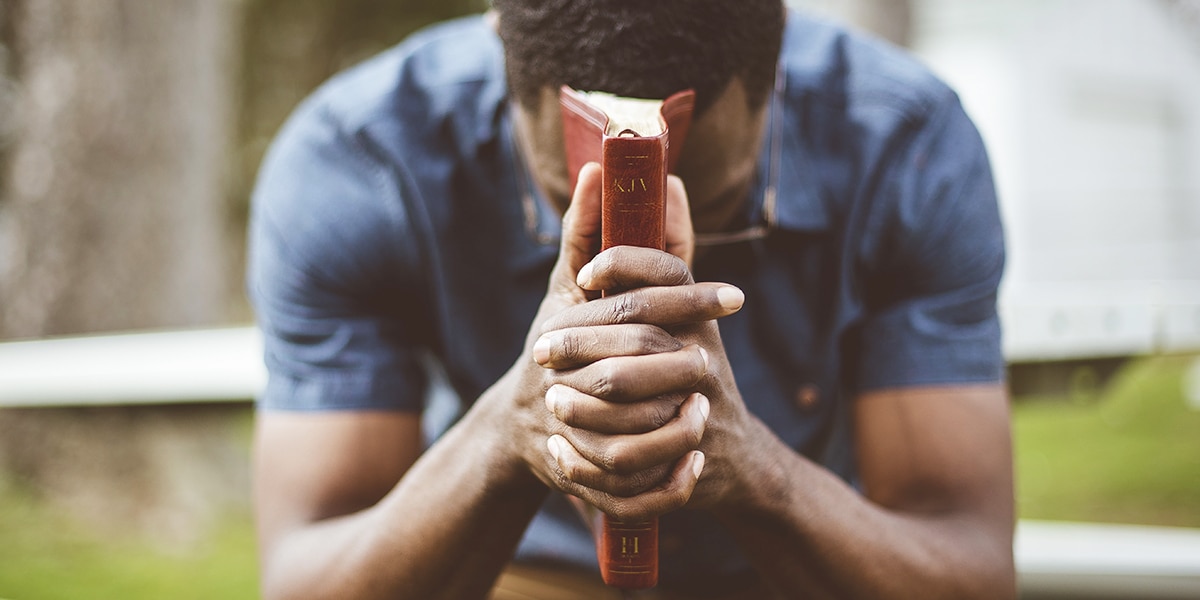 man struggling with forgiveness, praying