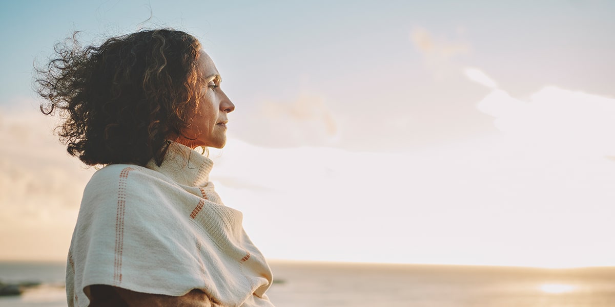 Middle aged woman looking into the distance.