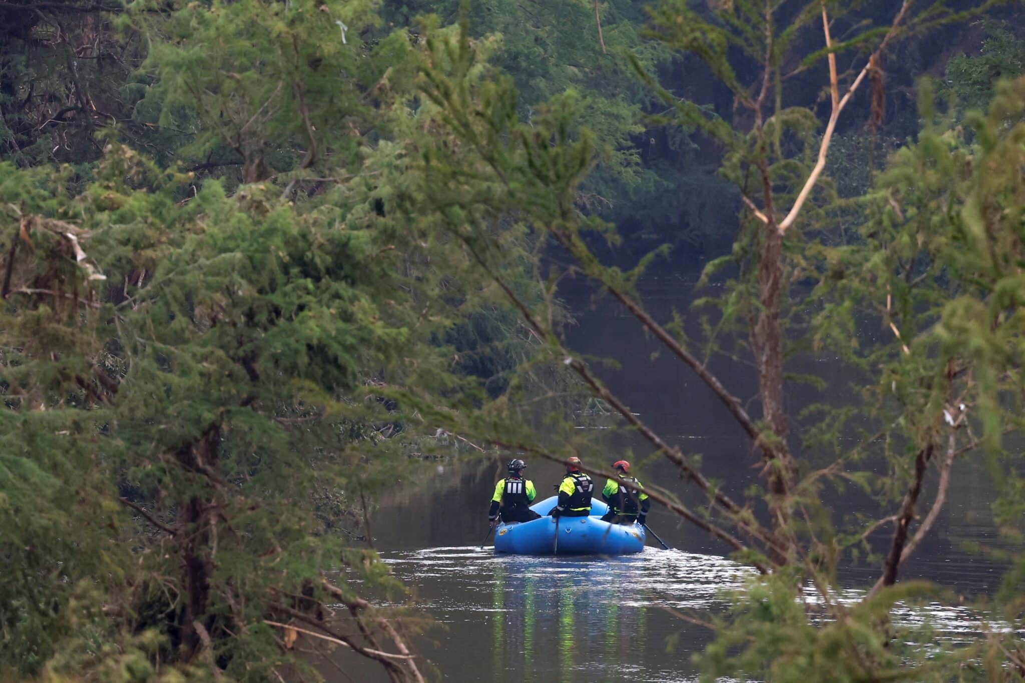 Rescuers paddle an inflatable boat as they search along a waterway in the aftermath of deadly flooding in Kerrville, Texas, July 6, 2025. At least 82 people are dead and at least 41 more are missing after devastating flash floods slammed the Texas Hill Country, with water rescues taking place along the Guadalupe River, which rose rapidly early July 4 to the height of a two-story building. Among the missing were almost a dozen from Camp Mystic in Kerr County, a children's summer camp, officials said July 6. (OSV News photo/Marco Bello, Reuters)
