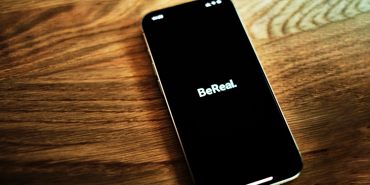 a cell phone with the words "Be Real"