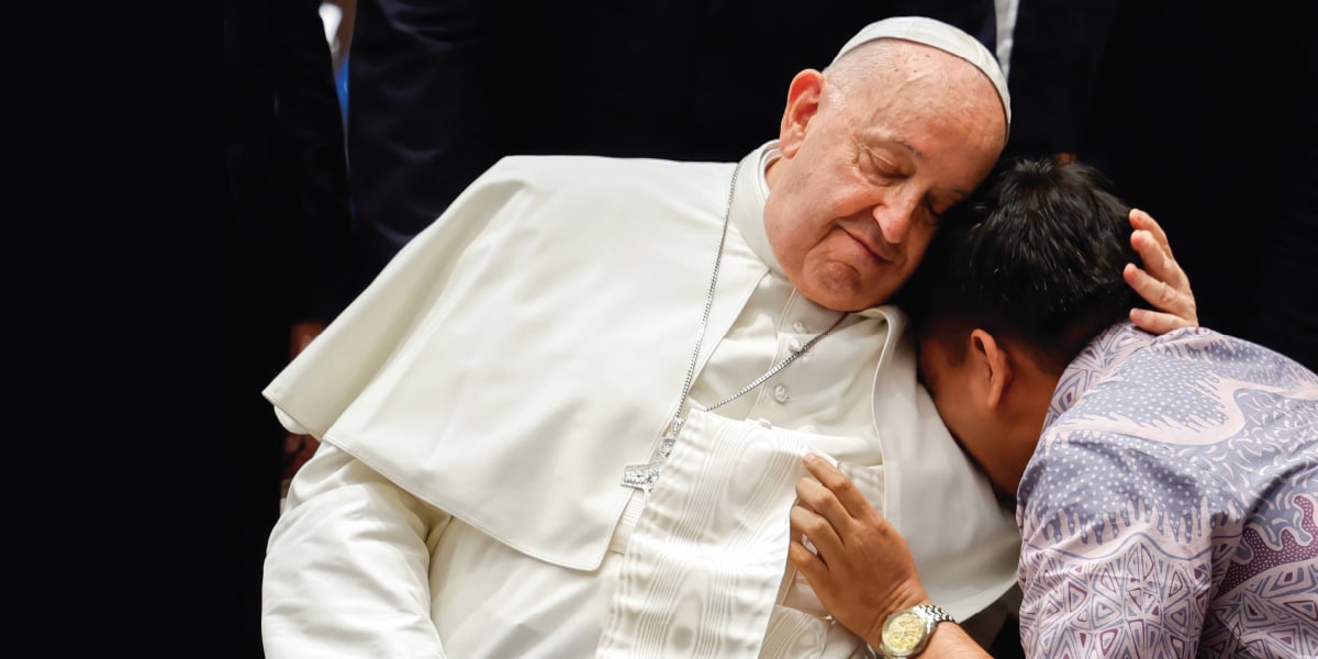 Pope Francis comforts a child
