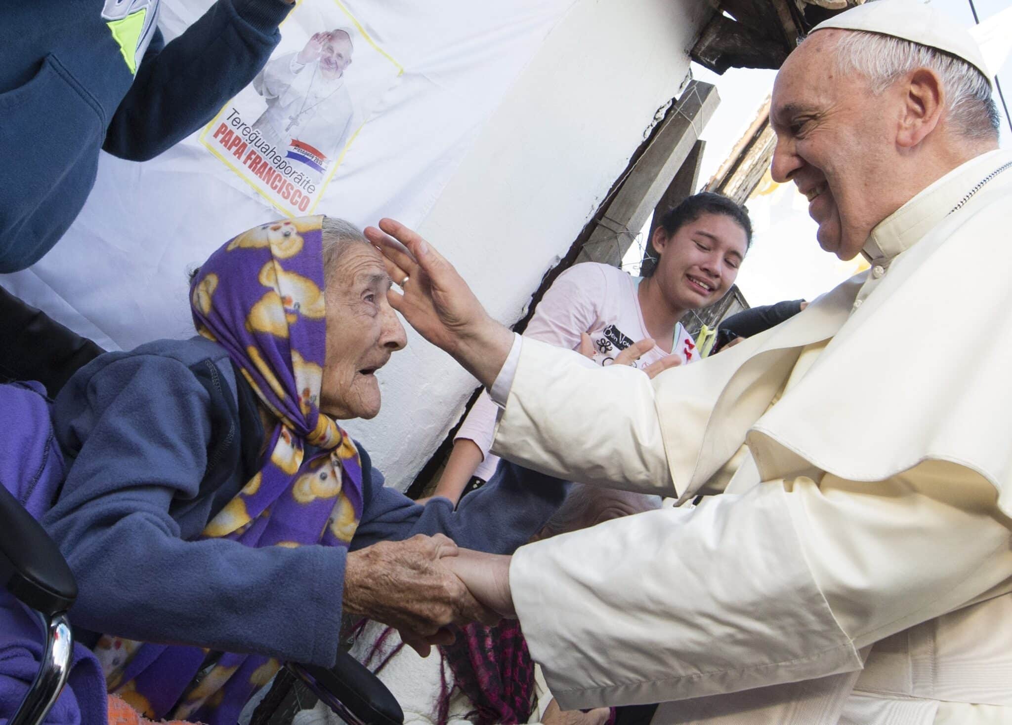 Pope Francis greets an elderly woman as he meets with people in Asuncion, Paraguay, July 12, 2015. The pope in January 2021 established the World Day for Grandparents and Elderly, celebrated annually on the fourth Sunday of July, near the July 26 liturgical memorial of Jesus' grandparents Sts. Joachim and Anne. (CNS photo/Paul Haring)