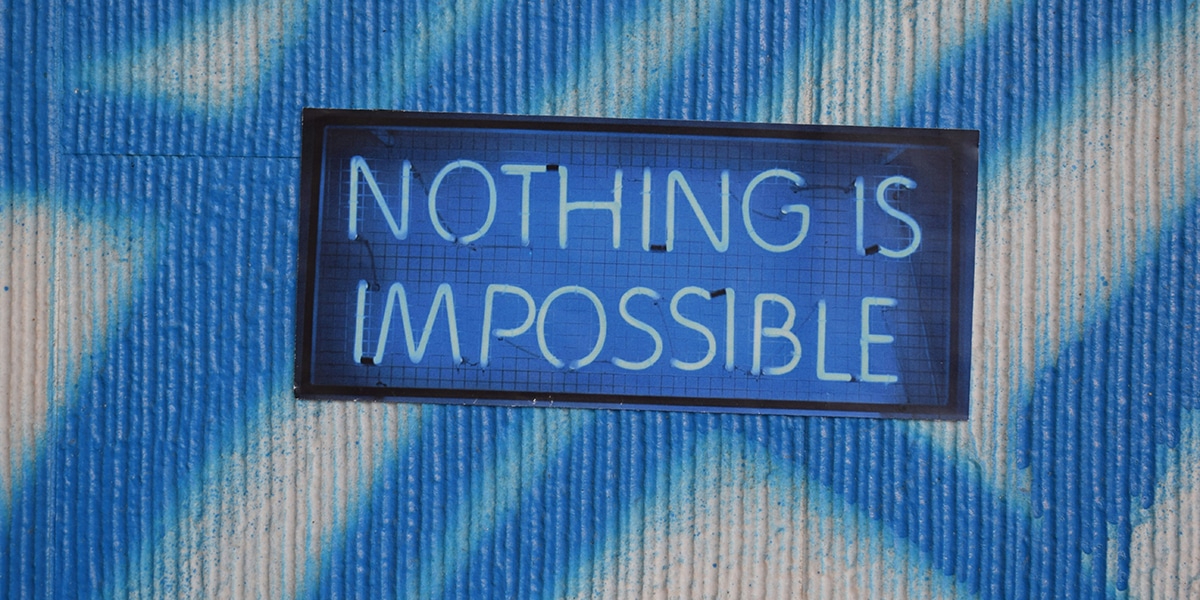 Graffiti and a sign that says "Nothing is Impossible"
