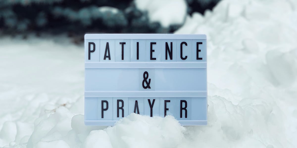 white sign with the words patience & prayer