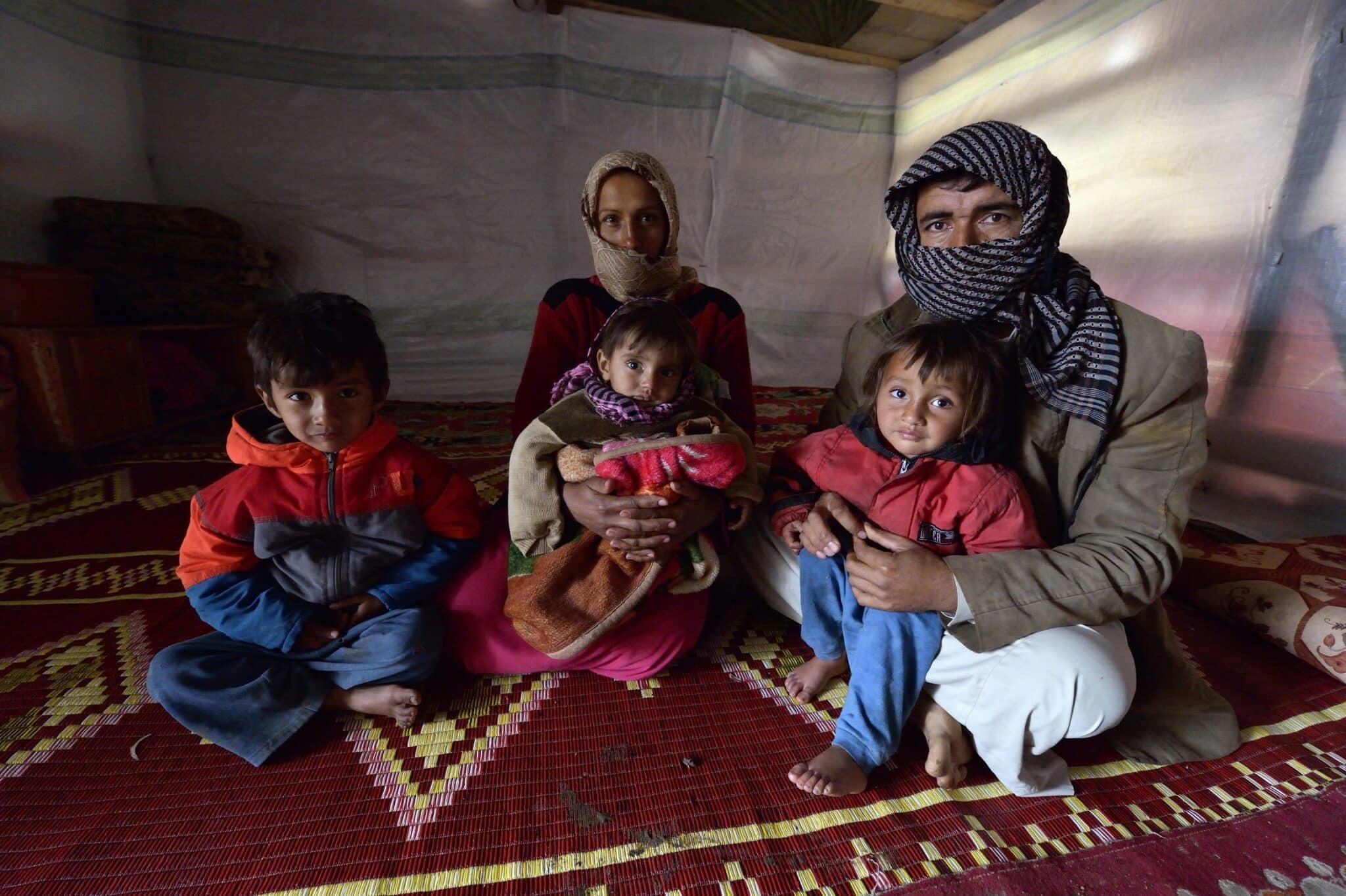 A displaced Syrian family are pictured in a file photo inside their tent at a refugee camp in the village of Jeb Jennine, in Lebanon's Bekaa Valley. (OSV News photo/Paul Jeffrey)