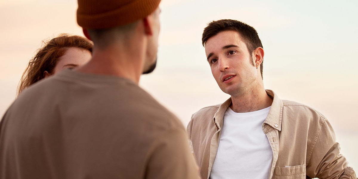 Three adults having a conversation.