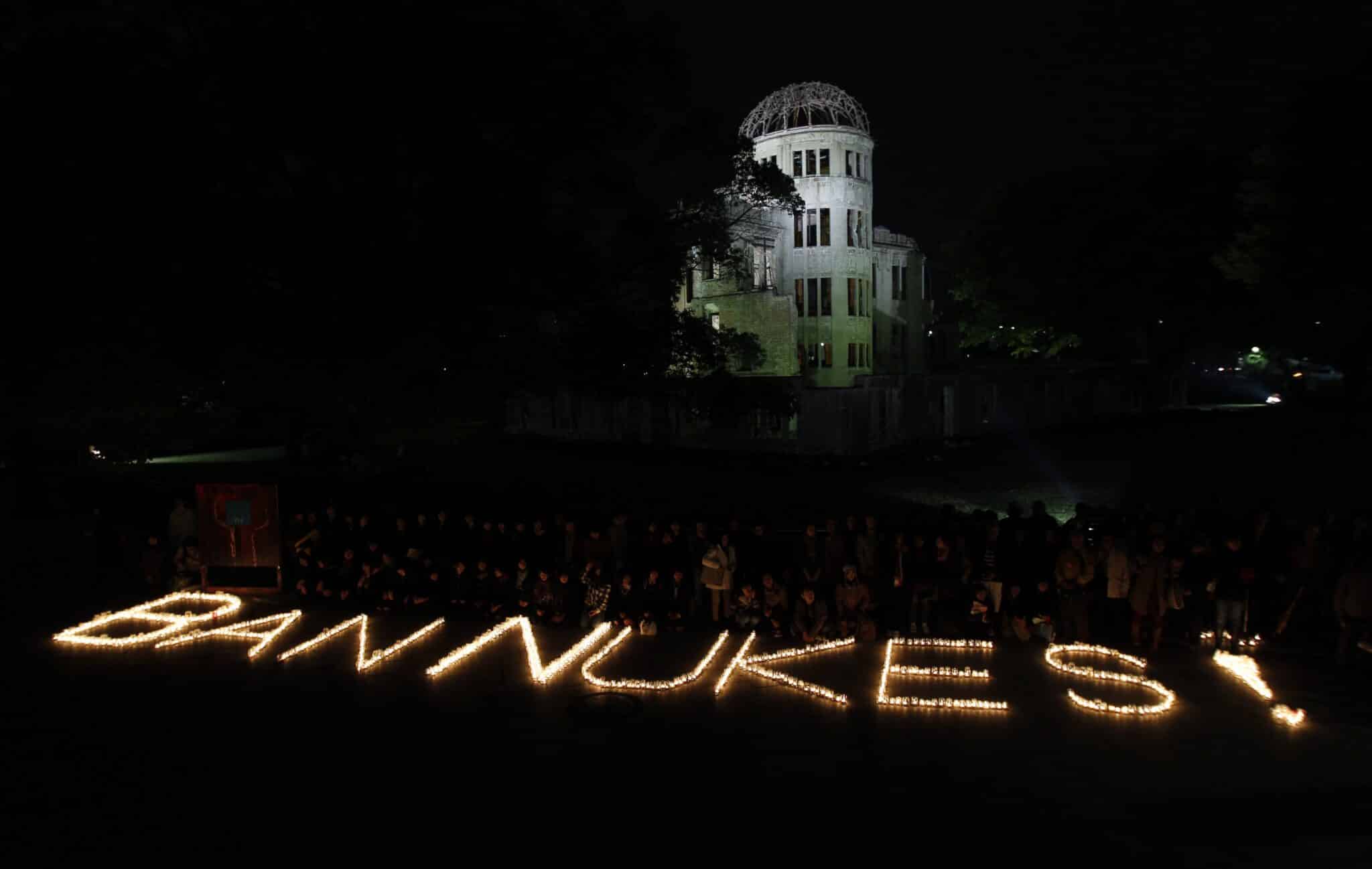 A file photo shows a "BAN NUKES!" slogan which was made of candle lights in front of the gutted Atomic Bomb Dome in Hiroshima, western Japan.
