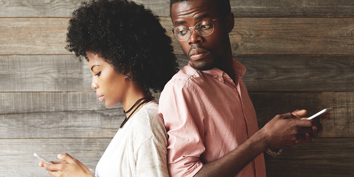 two people in a disagreement back to back