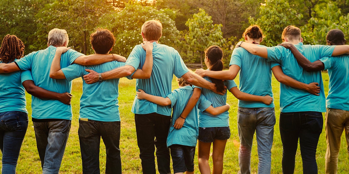 A group of volunteers in solidarity embracing each other.