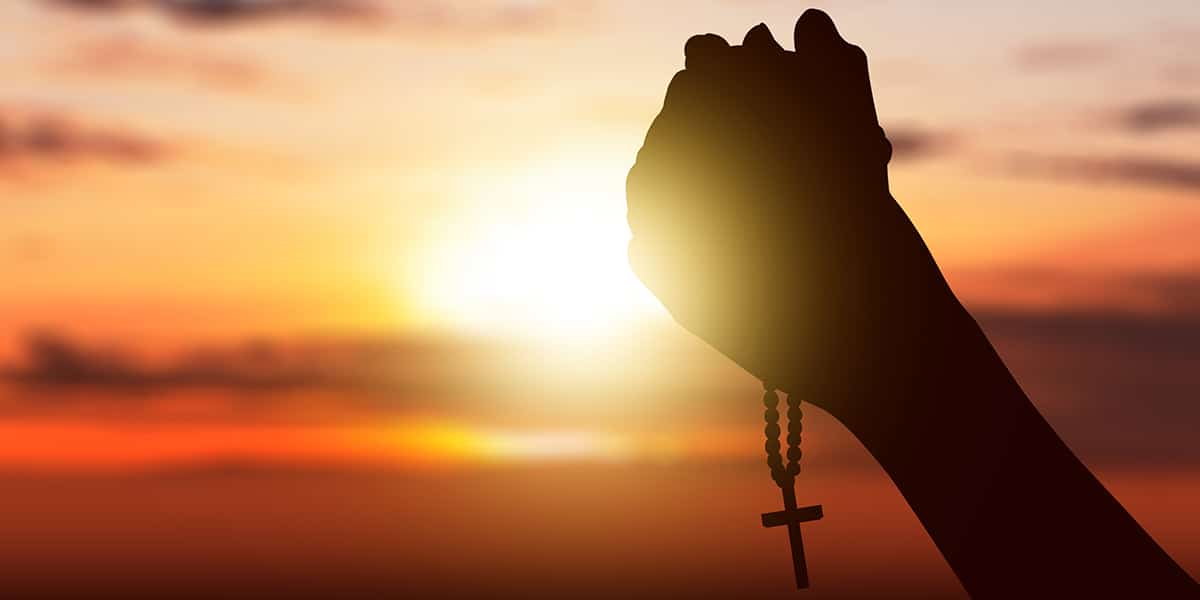 woman holding a rosary