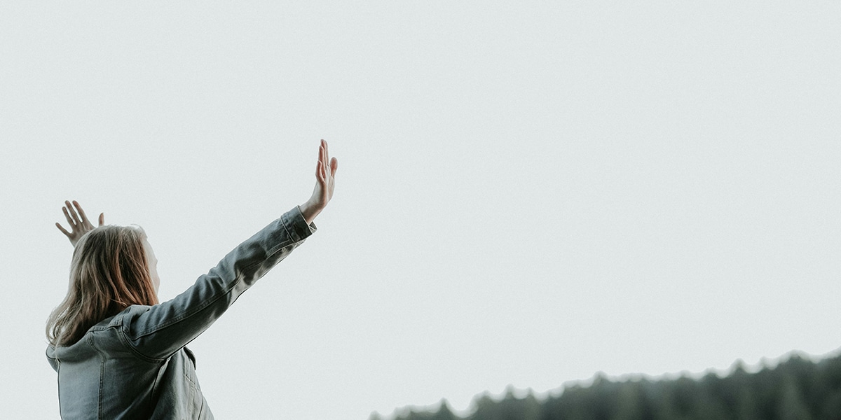 woman raising her arms