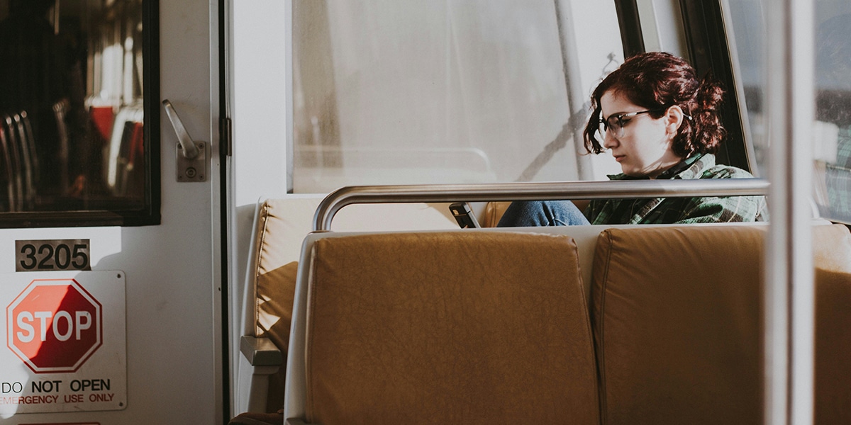 woman commuting in a train to and from work