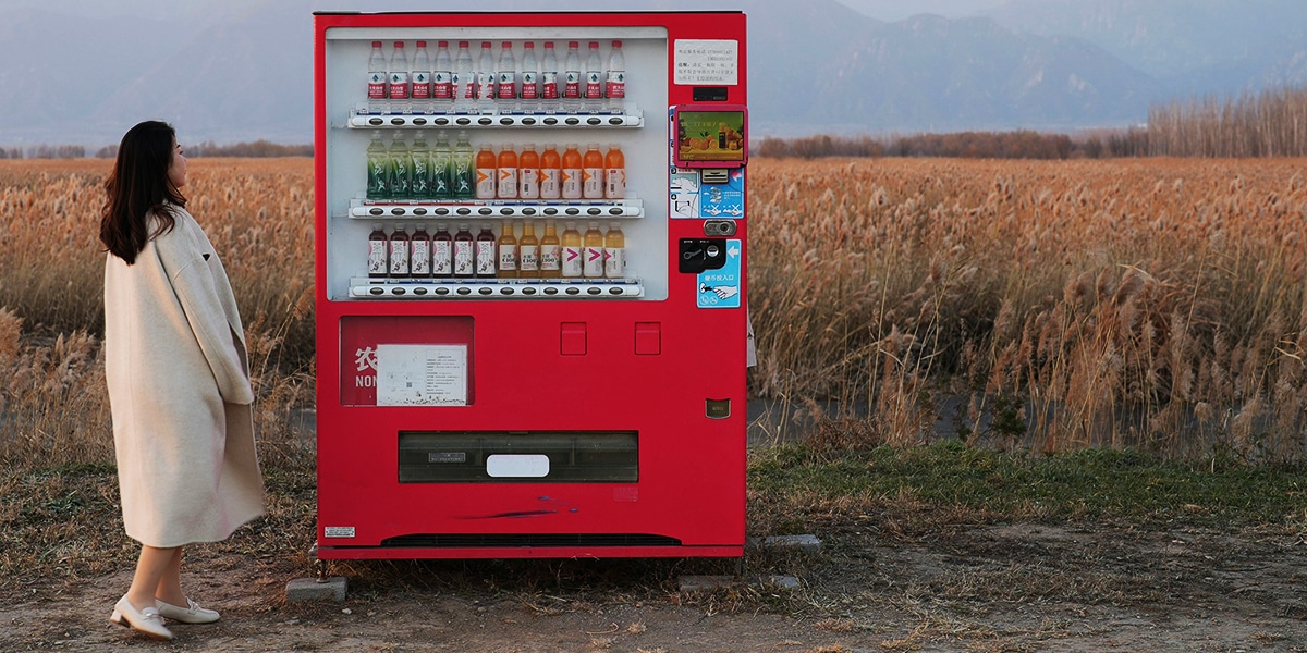 woman standing in front of a vending machine
