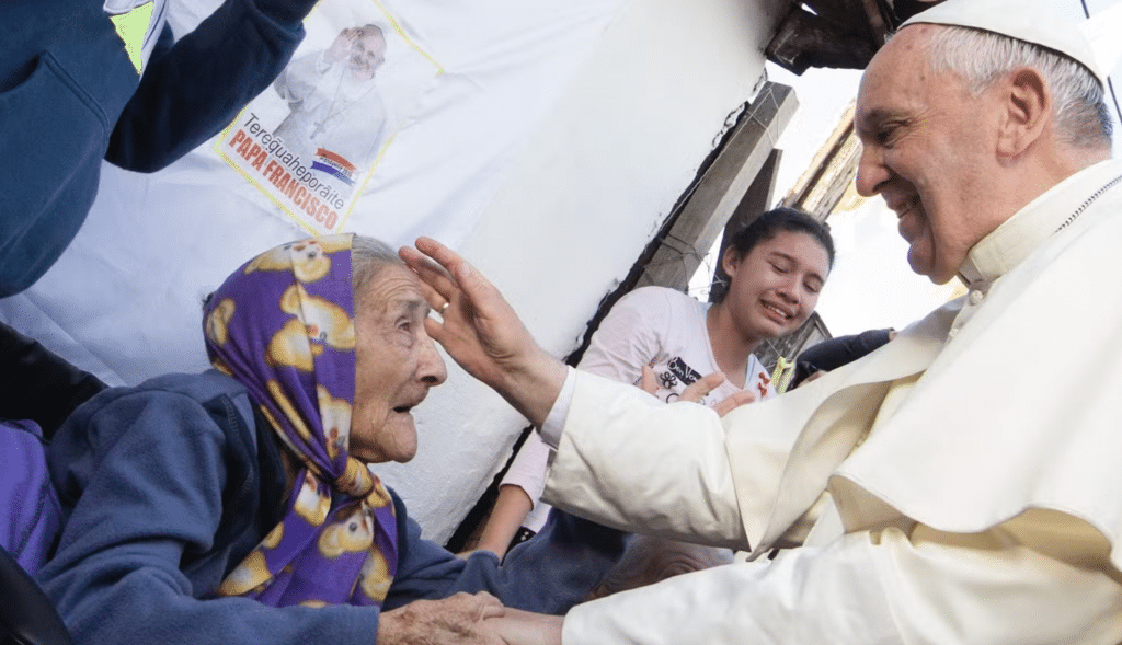 Pope Francis comforts an elderly woman